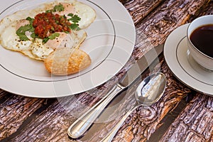 Over-easy eggs with fresh slasa and coffee