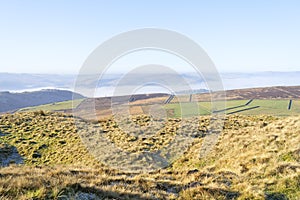 Over the fog covered low lands and valleys of the Derbyshire Peak District