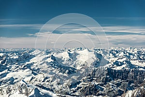 Over the mountain peaks covered with snow at winter