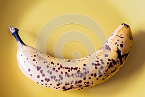 Over riped banana on yellow plate