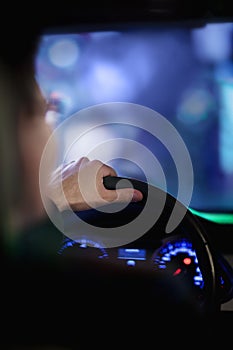 Over the shoulder view of businessman driving at night in the city