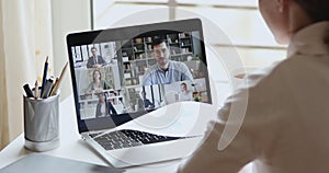 Over shoulder view of remote worker participating group virtual meeting