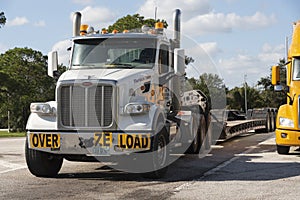 Over size load truck and low trailer on a Florida rest stop