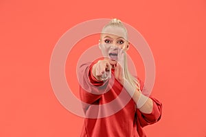 The overbearing business woman point you and want you, half length closeup portrait on coral background.