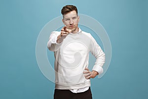 The overbearing businessman point you and want you, half length closeup portrait on blue background.