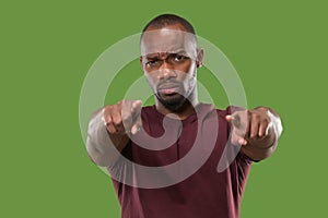 The overbearing businessman point you and want you, half length closeup portrait on green background.