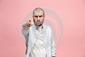 The overbearing businessman point you and want you, half length closeup portrait on pink background.