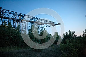 Overburden Conveyor Bridge F60 surrounded by greenery in the evening