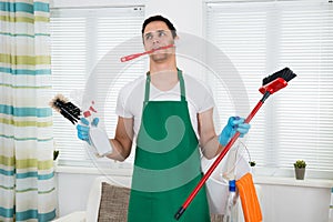 Overburdened Cleaner Holding Cleaning Equipment photo