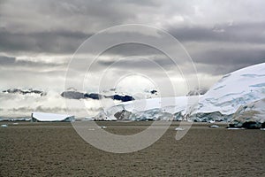 Overcast, glaciers falling into the sea