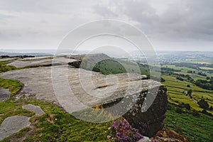 An overcast, misty summer morning high on Curbar Edge in the Derbyshire Peak District