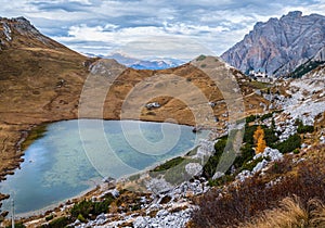 Overcast morning autumn alpine Dolomites mountain scene. Peaceful Valparola Path and Lake view, Belluno, Italy