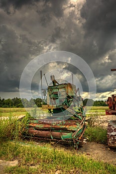 Overcast sky over abandoned farm equipment