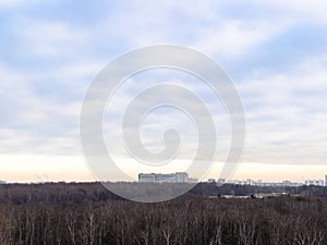 Overcast sky over city park in autumn morning