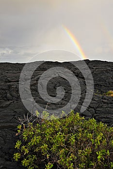 Overcast Sky with Rainbow and Black Lava