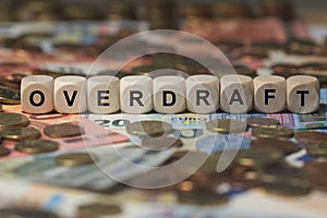 Overdraft - cube with letters, money sector terms - sign with wooden cubes photo