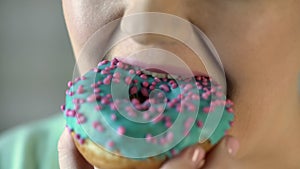 Overeating, plump woman biting donut, diabetes, hunger and obesity, closeup photo