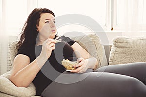 Fat woman overeating junk food. sedentariness