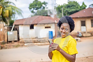 Overexcited African-American female using a smartphone checking social media and shopping online