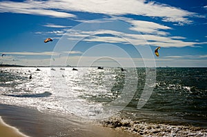 Overexposed effect with the sunset with kite surfers