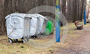 overfilled trash of large wheelie bins for rubbish, recycling and garden waste