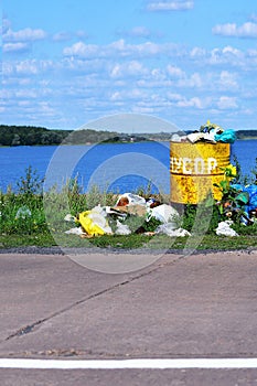 Overflowing barrel with rubbish and waste disposal on the waterf