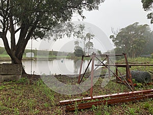 An overflowing farm dam after the rain