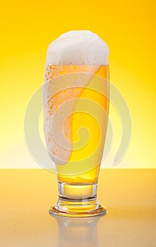 Overflowing pale lager beer photo