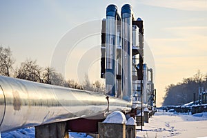 Overground heat pipes. Pipeline above ground, conducting heat for heating the city. Winter. Snow.