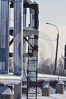 Overground heat pipes. Pipeline above ground, conducting heat for heating the city. Winter. Snow
