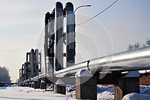 Overground heat pipes. Pipeline above ground, conducting heat for heating the city. Winter. Snow