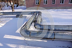 Overground heat pipes. Pipeline above ground, conducting heat for heating the city. Winter. Snow photo