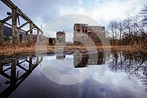 Overgrown ruins of industrial building. Abandoned, destroyed by war coal processing factory in Tkvarcheli Tquarhcal, Abkhazia,