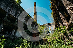 Overgrown ruins of industrial building. Abandoned, destroyed by war power plant in Tkvarcheli Tquarhcal, Abkhazia, Georgia