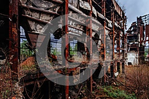 Overgrown ruins of industrial building. Abandoned, destroyed by war power plant in Tkvarcheli Tquarhcal, Abkhazia, Georgia