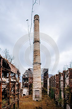 Overgrown ruins of industrial building. Abandoned, destroyed by war power plant in Tkvarcheli Tquarhcal, Abkhazia, Georgia