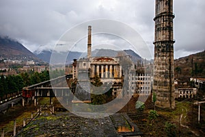 Overgrown ruins of industrial building. Abandoned, destroyed by war power plant in Tkvarcheli Tquarhcal, Abkhazia, Georgia