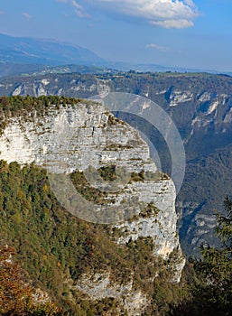 Overhang of a steep mountain and in the background the Asiago pl photo