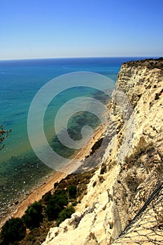 Overhanging clay rock on turquoise sea