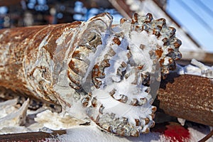 Overhaul of gas wells, oil rig platform drill bit close up teeth detail