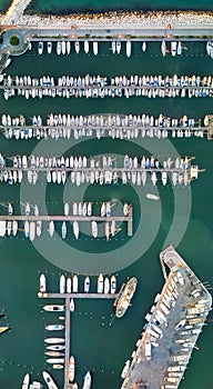 Overhead aerial view of small boats docked in the port, panoramic drone viewpoint