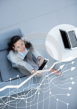 Overhead of business woman sitting with white graph