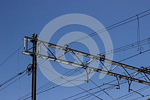 Overhead cable catenary train on a blue sky