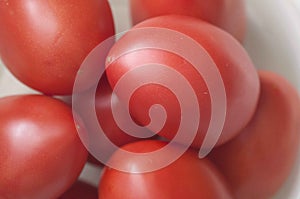 An overhead and close fresh tomatoes, white background