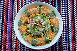 Overhead closeup  shot of red bell pepper, carrot, broccoli, parsley, and quinoa salad