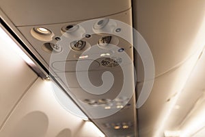 Overhead console in the modern passenger aircraft. air conditioner button and lighting switch