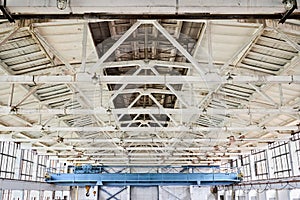 Overhead crane and concrete floor complex vaulted ceiling with crossbars beams ceilings inside factory building for