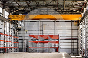 Overhead crane in a empty industrial warehouse building photo