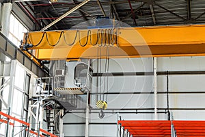 Overhead crane with hook in engineering plant shop