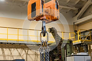 Overhead crane in the workshop for lifting and moving parts
